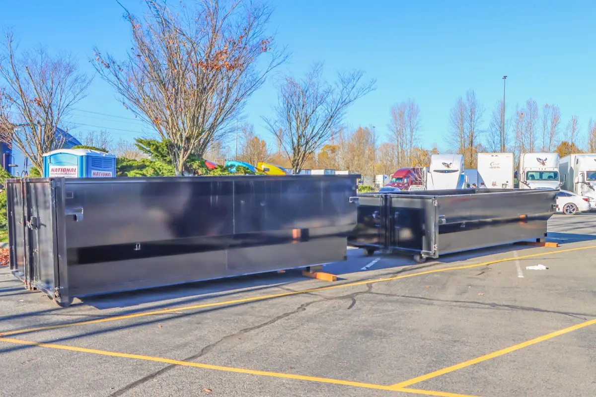 Professional dumpster rental service with roll-off container on residential driveway in Jurupa Valley